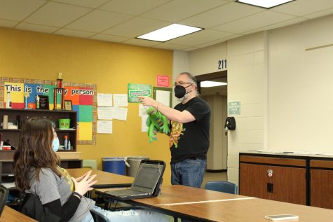 Mr. Greene teaches with his puppet, Dragon.