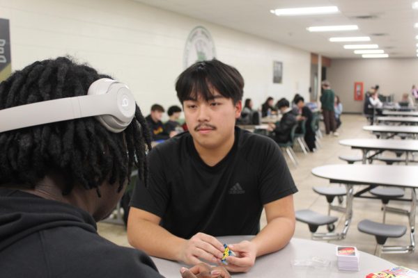 Senior Chayeng Xiong plays a game of uno during study hall with senior Tristan Steed.